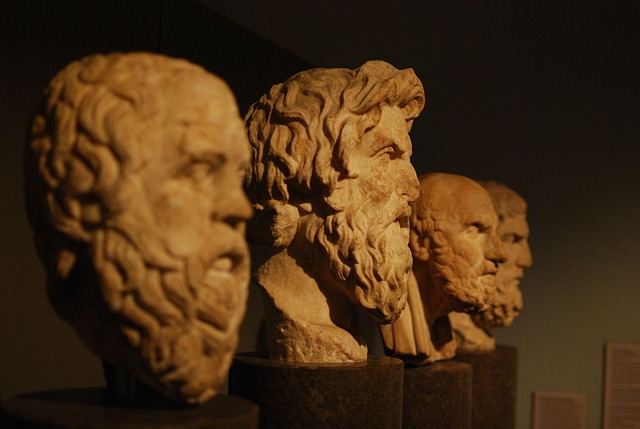 Ancient Greek philosophers discussing ideas in a marble courtyard – Greek Philosophy"